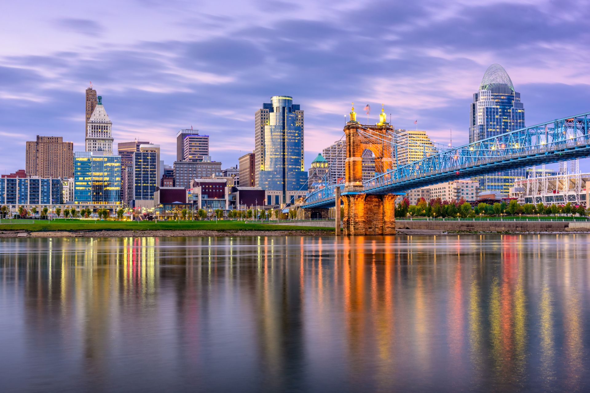 Cincinnati, Ohio, USA downtown and bridge over the river at sunset.