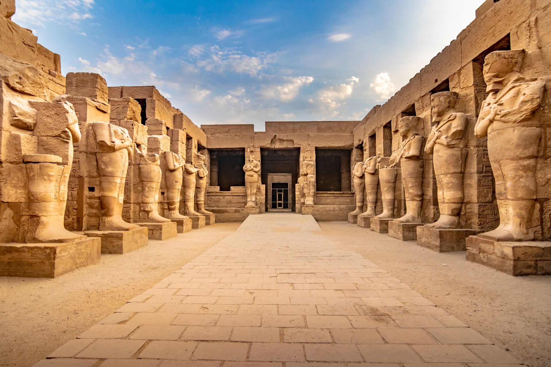 pharaoh sculptures inside a beautiful egyptian monument with hieroglyphs